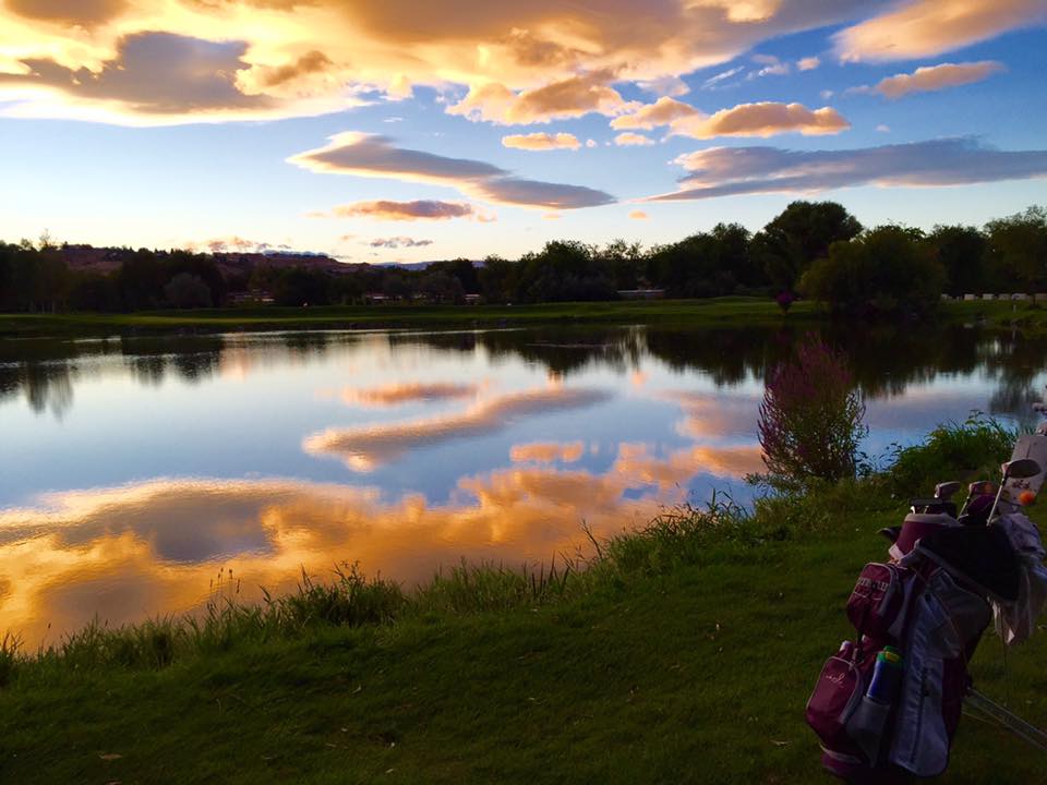 Panoramic view of a lush green golf course at River Ridge Golf Course. Smooth