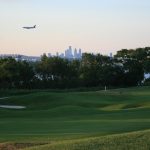 Panoramic view of a lush green golf course at RiverWinds Golf & Tennis Club. Smooth