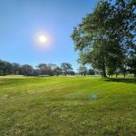 Panoramic view of a lush green golf course at Riverbend Golf Course. Smooth