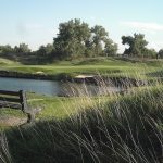 Panoramic view of a lush green golf course at Riverdale Golf Courses. Smooth