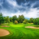 Panoramic view of a lush green golf course at Riverside Golf Course. Smooth