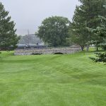 Panoramic view of a lush green golf course at Riverside Golf Course. Smooth