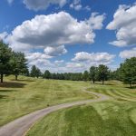 Panoramic view of a lush green golf course at Rochester Country Club. Smooth