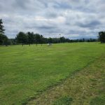 Panoramic view of a lush green golf course at Rocky Knoll Country Club. Smooth