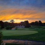 Panoramic view of a lush green golf course at Rolling Hills Country Club. Smooth