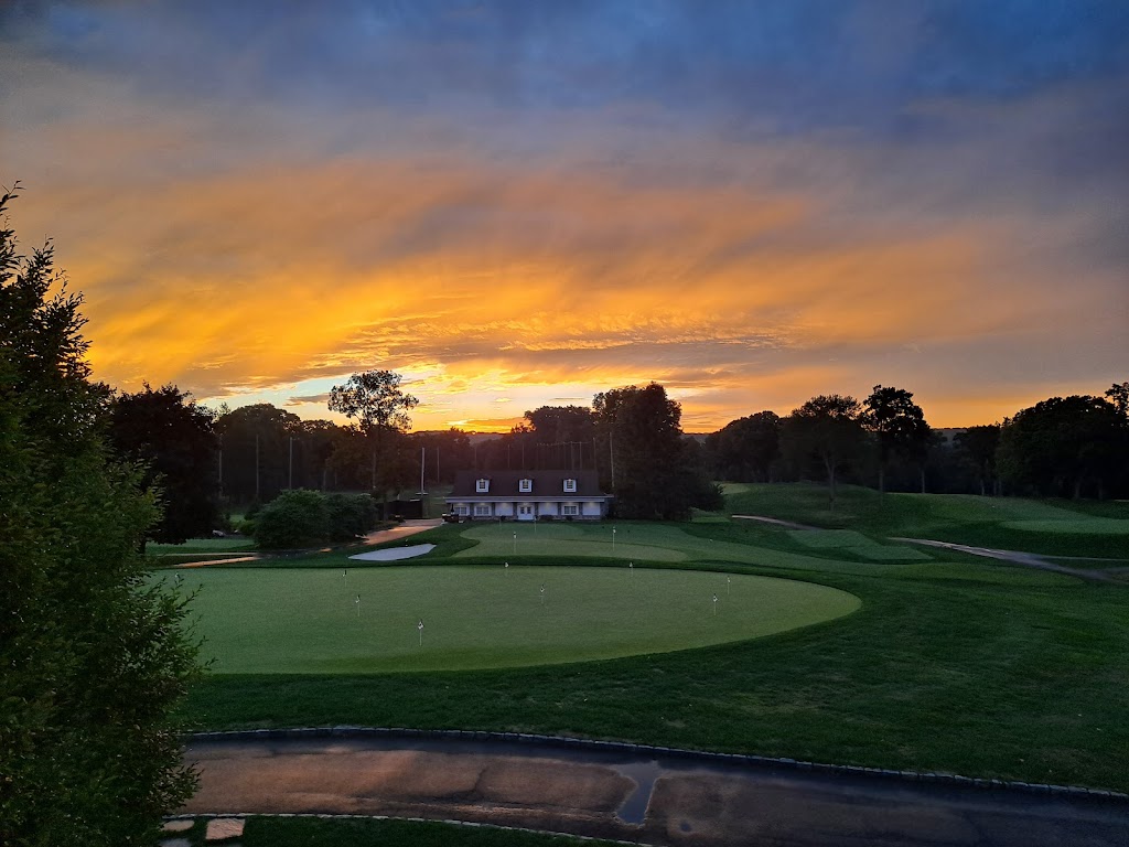 Panoramic view of a lush green golf course at Rolling Hills Country Club. Smooth