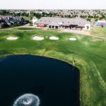 Panoramic view of a lush green golf course at Rose Creek Golf Club. Smooth