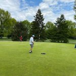 green grass with the flag in the hole.