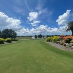 Panoramic view of a lush green golf course at Royal Lakes Golf Course. Smooth