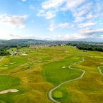 Panoramic view of a lush green golf course at Royal Manchester Golf Links. Smooth