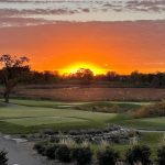 Panoramic view of a lush green golf course at Rush Creek Golf Club. Smooth