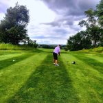 green grass with the flag in the hole.