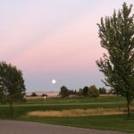 Panoramic view of a lush green golf course at Sage Lakes Golf Course. Smooth