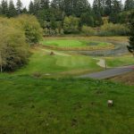 Panoramic view of a lush green golf course at Salmon Run Golf Course. Smooth