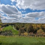 Panoramic view of a lush green golf course at Sandhill River Golf Course. Smooth