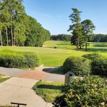 Panoramic view of a lush green golf course at Sanford Golf Course. Smooth