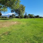 Panoramic view of a lush green golf course at Santa Anita Golf Course. Smooth