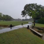 Panoramic view of a lush green golf course at Sara Bay Country Club. Smooth