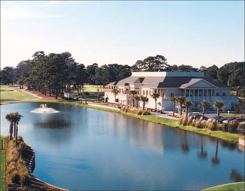 Panoramic view of a lush green golf course at Savannah Country Club. Smooth