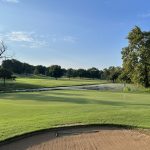 Panoramic view of a lush green golf course at Scotsdale Golf Course. Smooth