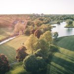 Panoramic view of a lush green golf course at Seven Bridges Golf Club. Smooth