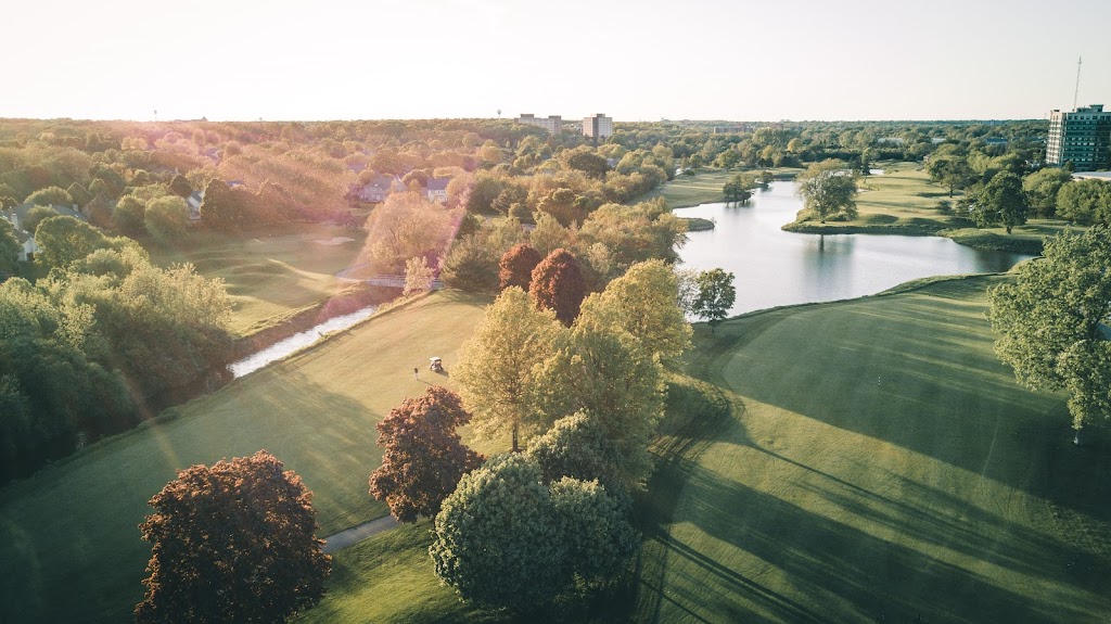 Panoramic view of a lush green golf course at Seven Bridges Golf Club. Smooth