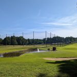 Panoramic view of a lush green golf course at Severna Park Golf Center. Smooth