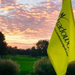 Panoramic view of a lush green golf course at Shadowood Golf Course. Smooth