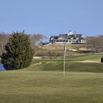 Panoramic view of a lush green golf course at Shelter Harbor Golf Club. Smooth