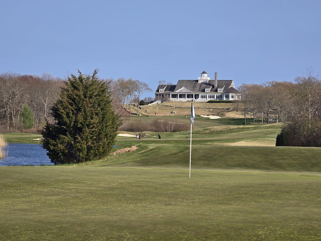 Panoramic view of a lush green golf course at Shelter Harbor Golf Club. Smooth