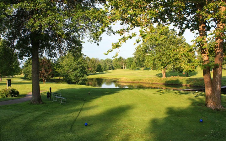 Panoramic view of a lush green golf course at Shirkey Golf Course. Smooth