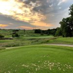 Panoramic view of a lush green golf course at Shoal Creek Golf Course. Smooth