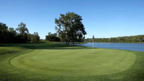 Panoramic view of a lush green golf course at Shoreline Golf Course. Smooth