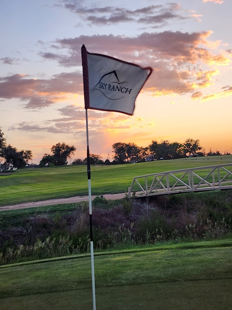 Panoramic view of a lush green golf course at Sky Ranch Golf Course. Smooth