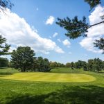 Panoramic view of a lush green golf course at Sligo Creek Golf Course. Smooth