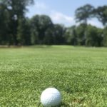 green grass with the flag in the hole.