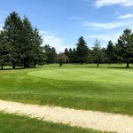 green grass with the flag in the hole.