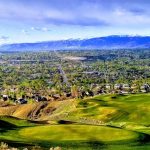 Panoramic view of a lush green golf course at South Mountain Golf Course. Smooth