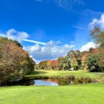 Panoramic view of a lush green golf course at South Shore Country Club. Smooth