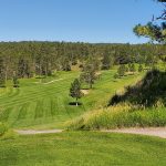 Panoramic view of a lush green golf course at Southern Hills Golf Course. Smooth