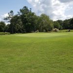 Panoramic view of a lush green golf course at Southern Oaks Golf Course. Smooth