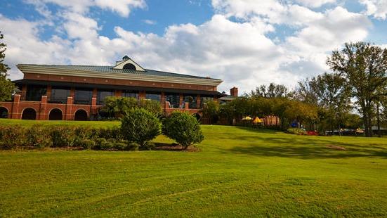 Panoramic view of a lush green golf course at Southern Trace Country Club. Smooth