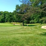 Panoramic view of a lush green golf course at Sparrows Point Country Club. Smooth