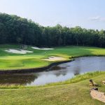 Panoramic view of a lush green golf course at Spring Creek Golf Club. Smooth