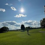 Panoramic view of a lush green golf course at Spring Green Golf Course. Smooth