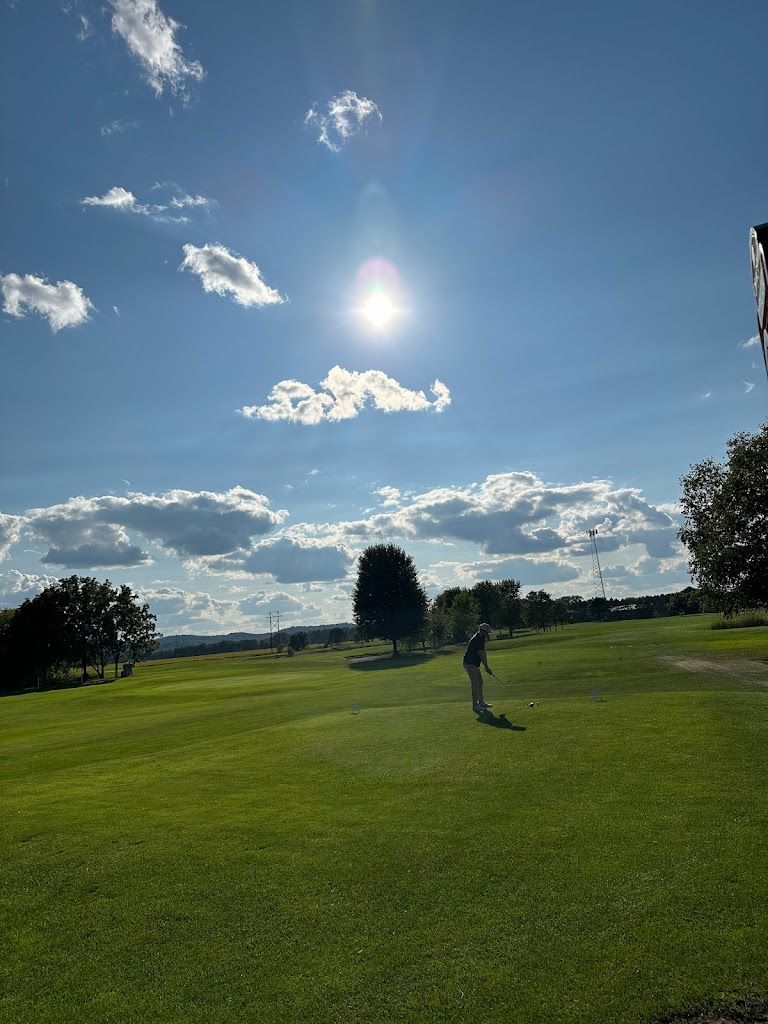 Panoramic view of a lush green golf course at Spring Green Golf Course. Smooth