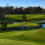 Panoramic view of a lush green golf course at Springdale Golf Course. Smooth