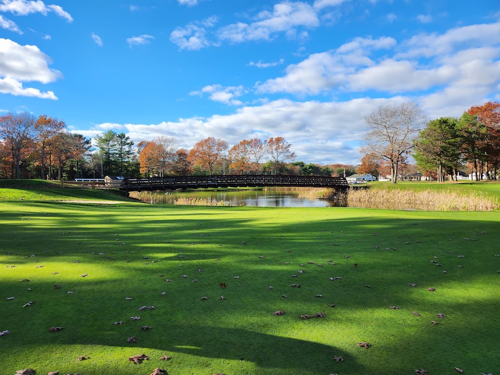 Panoramic view of a lush green golf course at Squirrel Run Country Club. Smooth