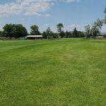 Panoramic view of a lush green golf course at Stillwater Golf. Smooth