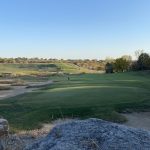 Panoramic view of a lush green golf course at Stone Canyon Golf Club. Smooth